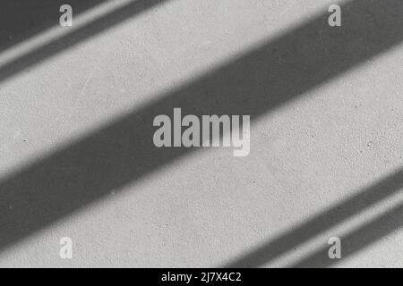 Shadows of window lines on a concrete stone wall in a bright room background. Abstract, geometry, light concept. High quality photo Stock Photo
