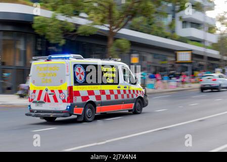A paramedic intensive care ambulance speeds along in the Pacific Highway in Chatswood, Sydney, Australia Stock Photo