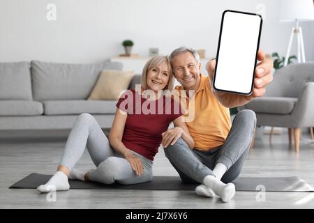 happy senior couple using fitness mobile application Stock Photo