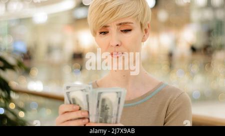 Headshot caucasian middle aged rich woman counting money checking cash salary bonus serious businesswoman with financial payment count bribe holding Stock Photo