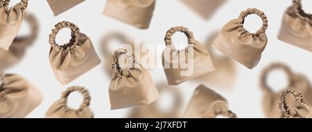 Brown eco-leather bags in the air on a gray background. A creative composition of a floating handbags. A conceptual banner of fashionable accessories Stock Photo