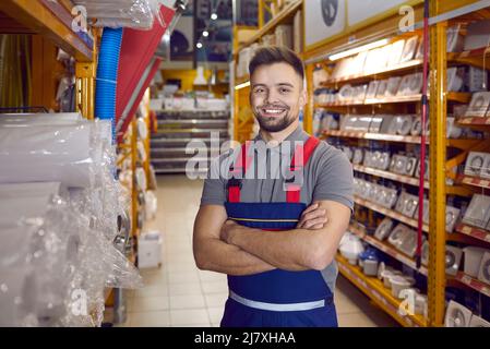 Confident friendly man working in warehouse in hypermarket of building materials. Stock Photo