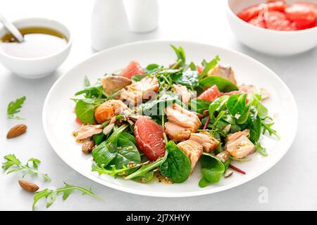 Grilled salmon salad with grapefruit, almonds and salad mix Stock Photo