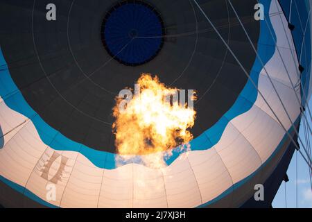 Flame from gas burner inflating hot air balloon. Stock Photo