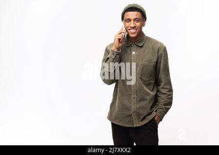 Young man talking phone, calling to somebody, looking at the camera with happy facial expression. Indoor studio shot isolated on white background Stock Photo