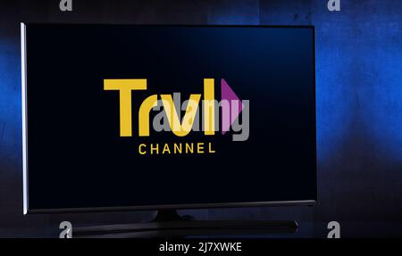 POZNAN, POL - MAR 25, 2022: Flat-screen TV set displaying logo of Travel Channel, an American pay television channel owned by Discovery, Inc. Stock Photo