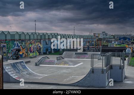 The skate park at The Big Beach Cafe owned by fat Boy Slim (Norman Cook) at Hove Lagoon on Hove seafront with the beach huts and street art Stock Photo