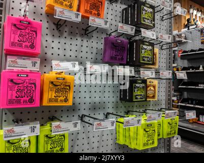 Lynnwood, WA USA - circa May 2022: Angled view of guitar strings for sale inside a Guitar Center musical instrument store Stock Photo