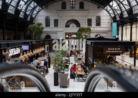 Oslo, Norway. May 02, 2022: Inside, view of Oslo Central Station with many stores and cafes where passengers can relax and eat. Stock Photo