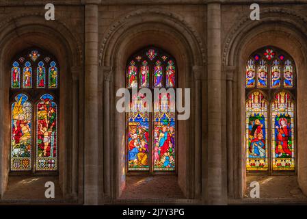 Edward Sparke's major campaign to reglaze Ely Cathedral with coloured glass resulted in these three colourful examples among many others Stock Photo