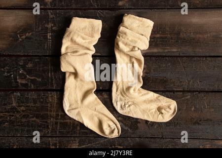 women's old socks lie on a wooden floor close-up, fashion Stock Photo