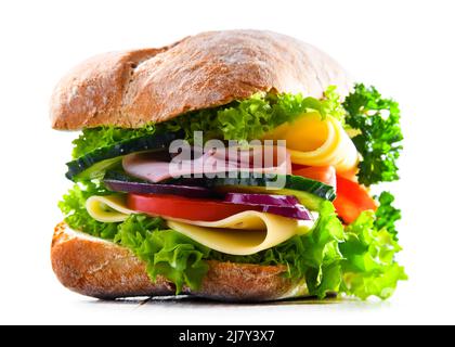 Sandwich with cheese and ham and fresh vegetables isolated on white. Stock Photo