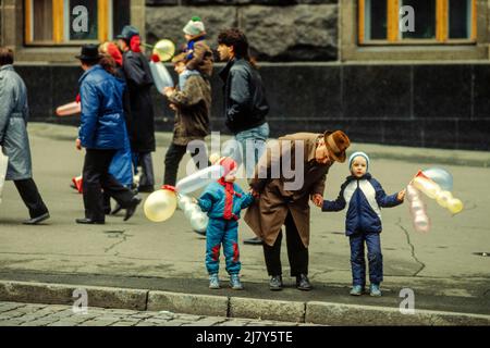 People buying supplies from a street stall as they set off to watch the USSR's Revolution Day parade in Kiev on 7th Nov 1989. Stock Photo