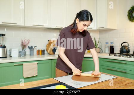 Young beautiful brunette caucasian woman 25s cooking in the kitchen Stock Photo