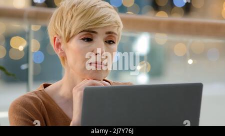 Headshot portrait thoughtful pensive female face doubtful middle-aged adult woman looking away thinking searching idea problem solution solving Stock Photo