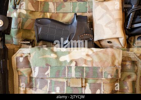 Military reinforced bulletproof vest and pistol, weapon, uniform of a Ukrainian soldier in the war, army of Ukraine 2022 Stock Photo
