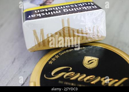 The Board of Directors of Swedish Match AB has noted the recent speculation and confirms that discussions with Philip Morris International Inc. regarding a possible public takeover offer for Swedish Match are ongoing. There can be no certainty that an offer will be made, nor as to the terms of any such potential offer, writes the company in a press release. In the picture: Marlboro gold cigarette pack, from Philip Morris International Inc.,  and General original snus frpm Swedish Match AB. Stock Photo