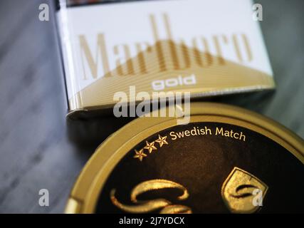 The Board of Directors of Swedish Match AB has noted the recent speculation and confirms that discussions with Philip Morris International Inc. regarding a possible public takeover offer for Swedish Match are ongoing. There can be no certainty that an offer will be made, nor as to the terms of any such potential offer, writes the company in a press release. In the picture: Marlboro gold cigarette pack, from Philip Morris International Inc.,  and General original snus frpm Swedish Match AB. Stock Photo