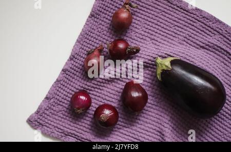 Red onion and kitchen towel isolated on white. autumn harvest, fresh vegetables Stock Photo