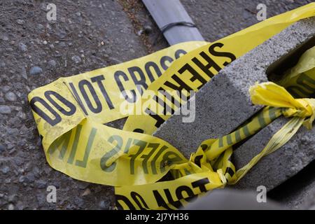 Yellow and black emergency lining with Sheriff Do Not Cross text. Stock Photo