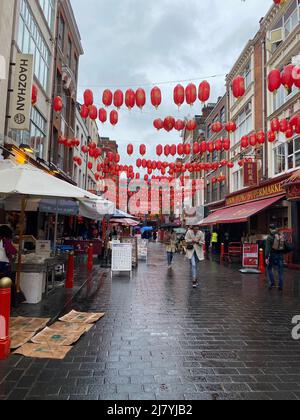 Lunar Year 2022 Chinatown , London as the days get longer that means winter is over , Chinatown is open again making a rapid economic recovery after the last two years of lockdowns and restrictions caused by Covid - 19 . All the shops are open now restaurants open ,cake shops and cafes up and running again . Fresh Fruit on sale everywhere giant durians for sale . Aromatic smells of the cooking from all the restaurants things rapidly going back to normal post pandemic . Stock Photo