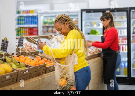 Middle-aged women selecting healthy food from the market Stock Photo