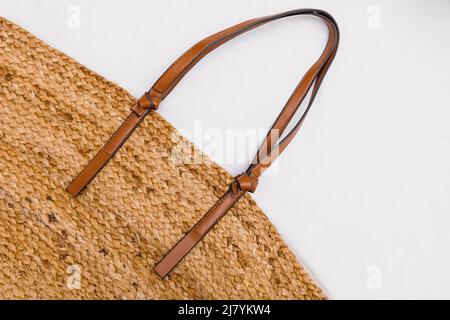Stylish straw bag on white background, top view. Summer accessories Stock Photo