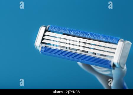 Blades of a new shaving machine on a blue background close-up free space Stock Photo