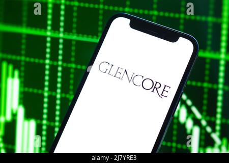 Poltava, Ukraine - May 11, 2022: Glencore logo company, gas and oil prices, energy industry. Petroleum stock market graphs, global financial backgroun Stock Photo