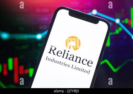 Poltava, Ukraine - May 11, 2022: Reliance logo company, gas and oil prices, energy industry. Petroleum stock market graphs, global financial backgroun Stock Photo