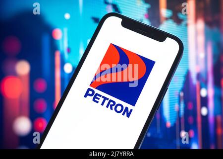 Poltava, Ukraine - May 11, 2022: Petron logo company, gas and oil prices, energy industry. Petroleum stock market graphs, global financial background. Stock Photo