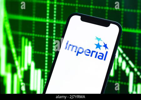 Poltava, Ukraine - May 11, 2022: Imperial logo company, gas and oil prices, energy industry. Petroleum stock market graphs, global financial backgroun Stock Photo