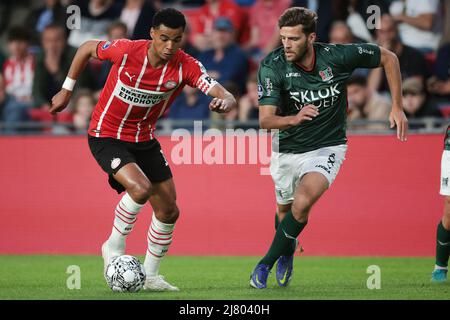 EINDHOVEN - (lr) Cody Gakpo of PSV Eindhoven, Javier Vet of NEC during the Dutch Eredivisie match between PSV Eindhoven and NEC at Phillips stadium on May 11, 2022 in Eindhoven, Netherlands. ANP JEROEN PUTMANS Stock Photo