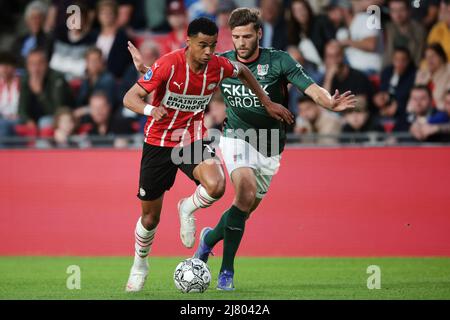 EINDHOVEN - (lr) Cody Gakpo of PSV Eindhoven, Javier Vet of NEC during the Dutch Eredivisie match between PSV Eindhoven and NEC at Phillips stadium on May 11, 2022 in Eindhoven, Netherlands. ANP JEROEN PUTMANS Stock Photo