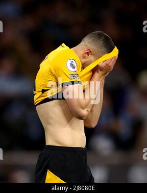 Wolverhampton Wanderers' Conor Coady reacts after Manchester City's Kevin De Bruyne scores his side's fourth goal of the game during the Premier League match at the Molineux Stadium, Wolverhampton. Picture date: Wednesday May 11, 2022. Stock Photo