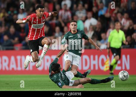 EINDHOVEN - (lr) Cody Gakpo of PSV Eindhoven, Ivan Marquez of NEC during the Dutch Eredivisie match between PSV Eindhoven and NEC at Phillips Stadium on May 11, 2022 in Eindhoven, Netherlands. ANP JEROEN PUTMANS Stock Photo