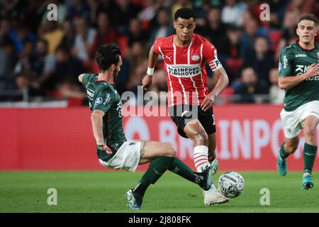 EINDHOVEN - (lr) Cody Gakpo of PSV Eindhoven, Ivan Marquez of NEC during the Dutch Eredivisie match between PSV Eindhoven and NEC at Phillips Stadium on May 11, 2022 in Eindhoven, Netherlands. ANP JEROEN PUTMANS Stock Photo