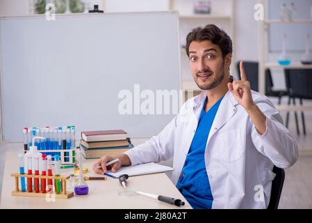 Young chemist working at the lab Stock Photo