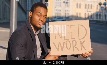 Looking for job. Fired millennial upset male. Businessman loosing business and searching employment in crisis. Sad mixed race young adult black man Stock Photo