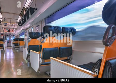 kyushu, japan - december 10 2021: Interior of the commuter train of Kyushu railway company, the JR Kyushu BEC819 series with spacious leather and wood Stock Photo