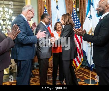 Washington, United States of America. 09 May, 2022. U.S Vice President Kamala Harris, right, congratulates Nick Perry, center, after being sworn in as the  new Ambassador to Jamaica as Senate Leader Chuck Schumer, left, looks on in the ceremonial office at the White House, May 9, 2022 in Washington, D.C. Credit: Lawrence Jackson/White House Photo/Alamy Live News Stock Photo