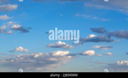 blue sky with sparse clouds at sunset Stock Photo
