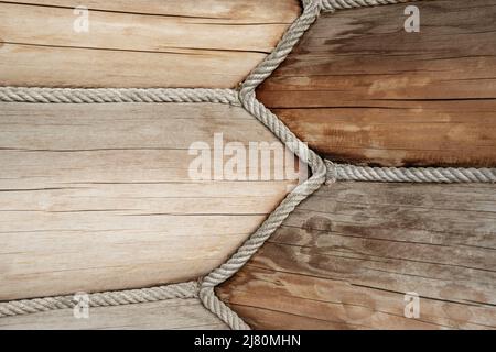 Close-up detail view of wooden log building corner joint decorated with jute rope isolation sealant. Timber beam wall cabin. Eco natural materials Stock Photo