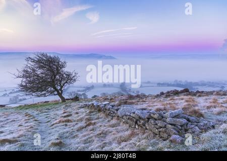 UK landscape photographer John Finney captured this stunning misty sunrise this morning over Win Hill in the Derbyshire Peak District, Derbyshire United Kingdom Featuring: Winhill and Bamford sunrise, Peak District. UK Where: Derbyshire, United Kingdom When: 01 Mar 2021 Credit: John Finney/WENN Stock Photo