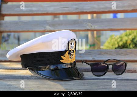 Greek naval officer, admiral, ship white captain cap with sunglasses Stock Photo