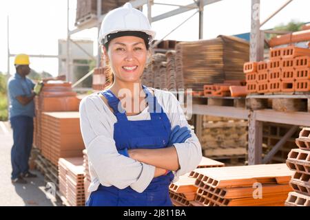 Asian woman worker posing at hardware store Stock Photo
