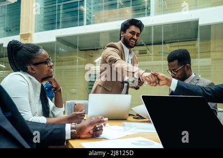 well-dressed business indian men making a report to subordinate employees in a modern office Stock Photo