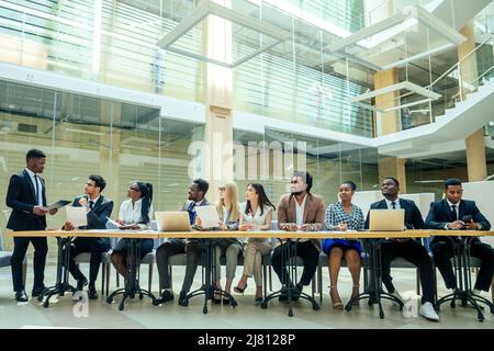 team work group of international business partners : indian,korean, afro-american people working together in modern room Stock Photo