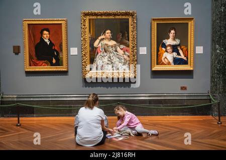 England, London,The National Gallery, Mother and Child Sitting in Front of Artwork Stock Photo