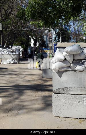 Odessa, Ukraine. 06th May, 2022. A woman is seen walking past a barricade of concrete and sandbags at St. Michael the Archangel Convent. (Photo by Viacheslav Onyshchenko/SOPA Images/Sipa USA) Credit: Sipa USA/Alamy Live News Stock Photo